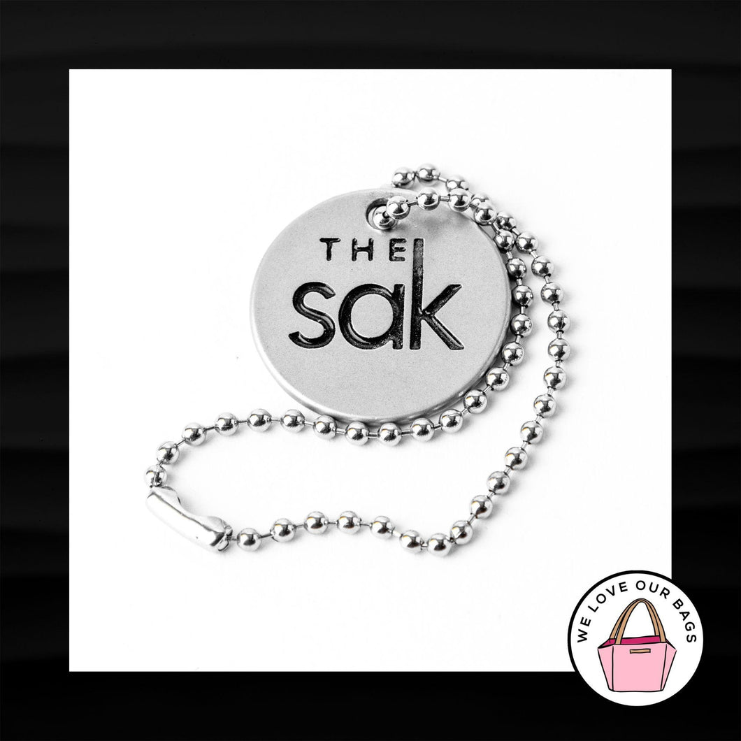 THE SAK EMBOSSED ROUND SILVER METAL DISC KEY FOB BAG CHARM KEYCHAIN HANG TAG